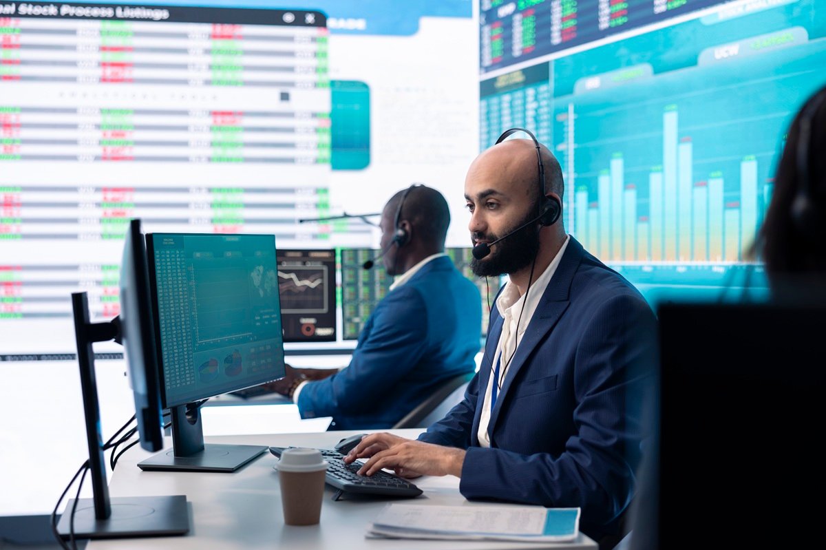 Focused team leader examining company numbers to calculate profit